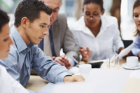 sales staff sitting at conference table